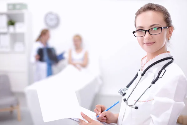 Mladá žena lékař stojící v nemocnici s lékařským stetoskopem — Stock fotografie