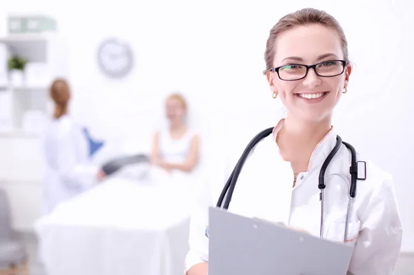 Young woman doctor standing at hospital with medical stethoscope — Stock Photo, Image