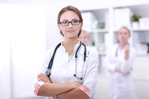 Young woman doctor standing at hospital with medical stethoscope — Stock Photo, Image