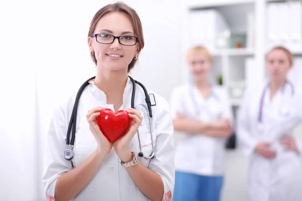 Doctor with stethoscope holding heart, isolated on white background — Stock Photo, Image