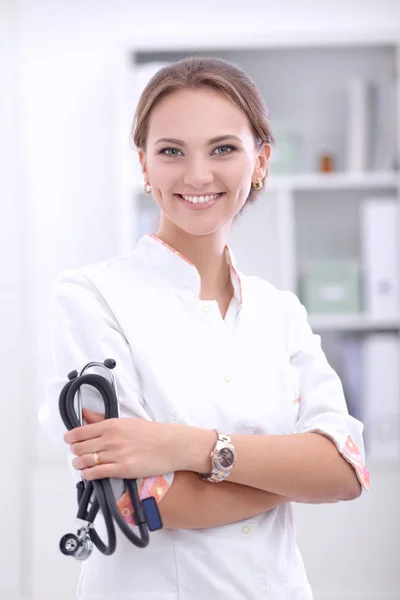 Young woman doctor standing at hospital with medical stethoscope — Stock Photo, Image