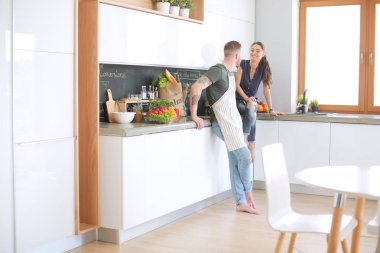 Güzel genç çift evde mutfakta eğleniyor.