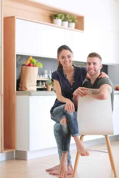 Beautiful young couple is having fun in kitchen at home — Stock Photo, Image