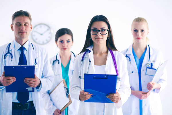 Portrait of group of smiling hospital colleagues standing together . Doctors