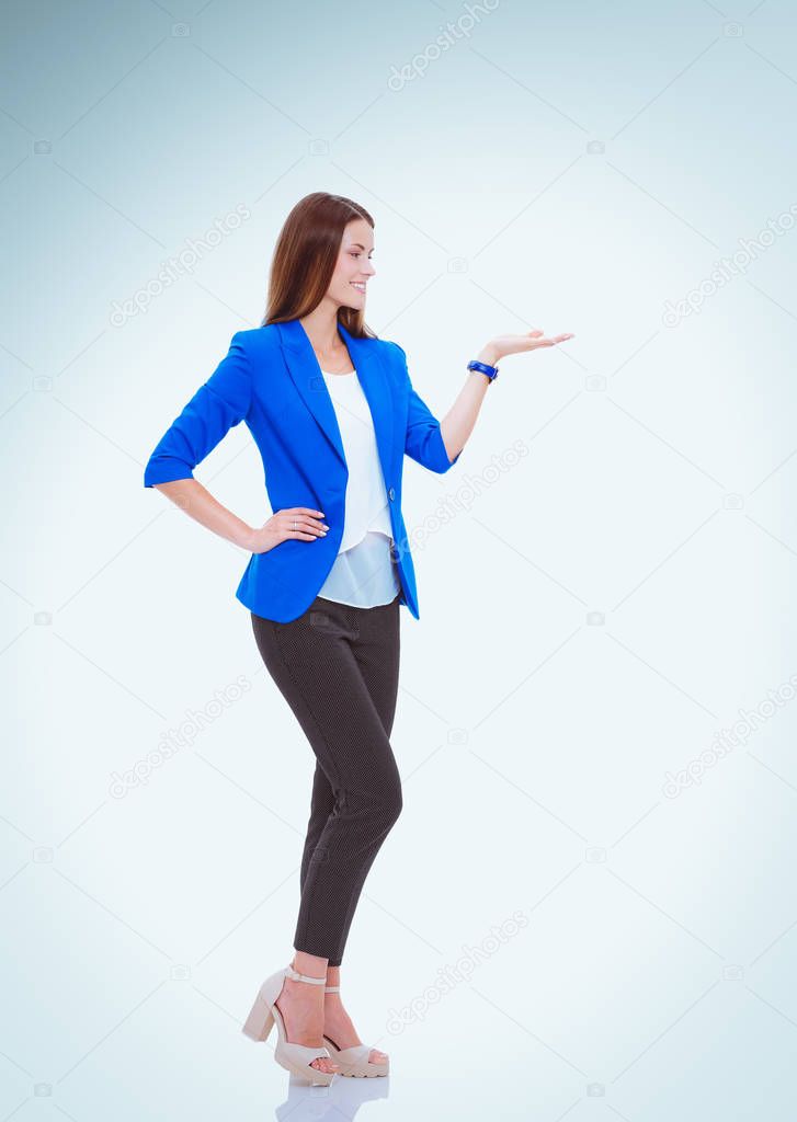Portrait of young business woman pointing