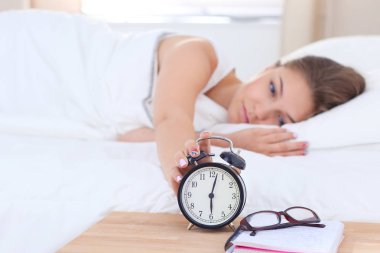 Genç bir kadın sabah alarmını erteliyor..