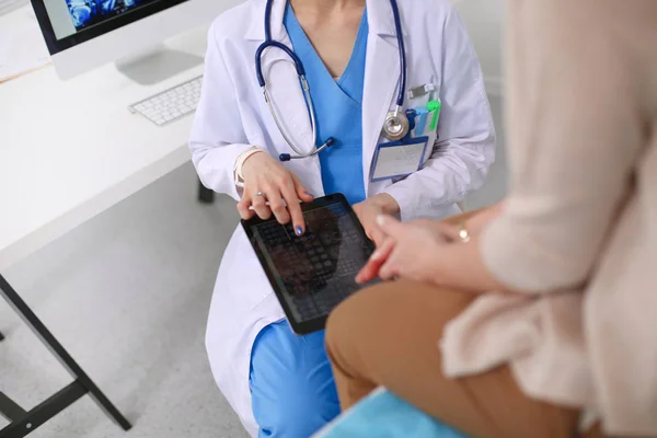 Doctor and patient discussing something while sitting at the table . Medicine and health care concept. Doctor and patient — Stock Photo, Image