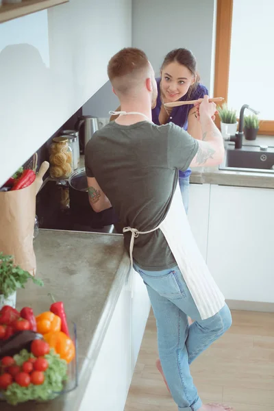 Couple cooking together in their kitchen at home — Stock Photo, Image