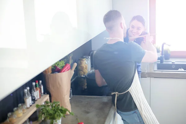 Couple cooking together in their kitchen at home — Stock Photo, Image