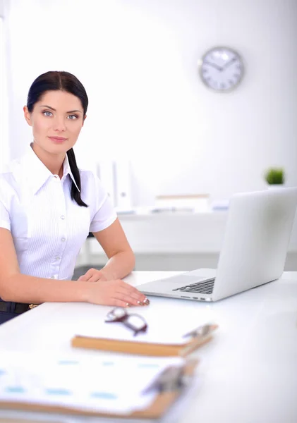 Attractive businesswoman sitting on desk in the office — Stock Photo, Image