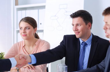 İş adamları iş toplantısında oturup tartışıyor.