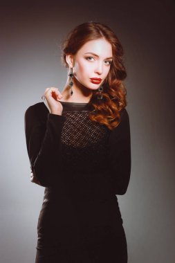 Siyah elbiseli, akşam makyajlı güzel bir kadın.