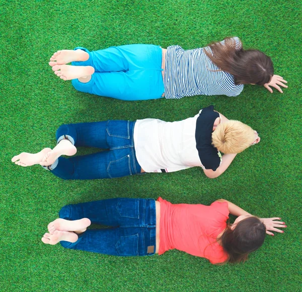 Jovens mulheres deitadas na grama verde — Fotografia de Stock