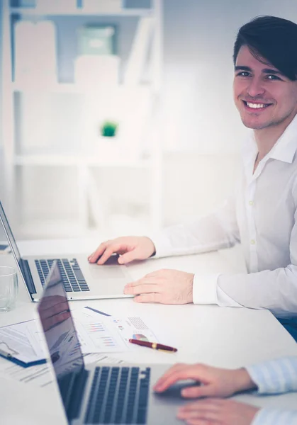 Young businessman working in office, sitting at desk — Stock Photo, Image