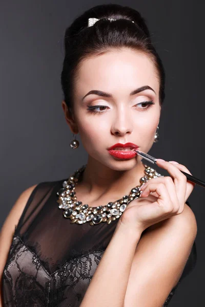 Portrait of young beautiful woman with jewelry — Stock Photo, Image