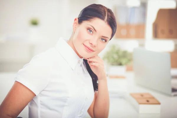 Attractive businesswoman sitting in the office, isolated — Stock Photo, Image