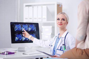 Doktor ve hasta masada otururken bir şey tartışıyorlar. Tıp ve sağlık hizmetleri kavramı. Doktor ve hasta.