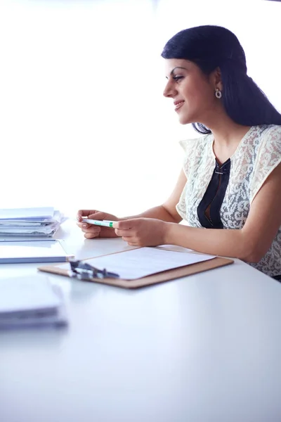 Mujer con documentos sentada en el escritorio — Foto de Stock