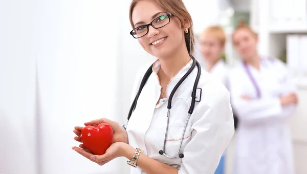 Doctor with stethoscope holding heart, isolated on white  background — Stock Photo, Image