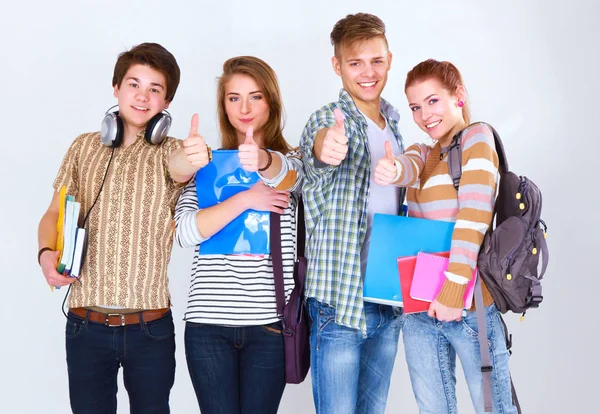 Grupo feliz de estudantes segurando cadernos, isolados em fundo branco Imagem De Stock