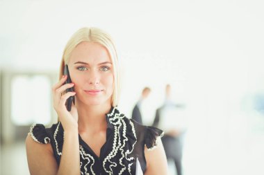 Ofiste cep telefonu kullanan güzel bir iş kadını. .