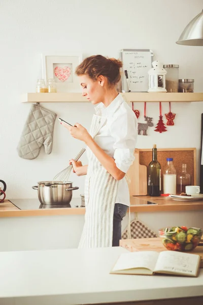 Smiling woman online shopping using computer and credit card in kitchen . Smiling woman — Stock Photo, Image
