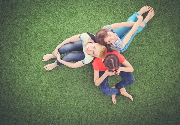 Young women lying on green grass . Young women — Stock Photo, Image