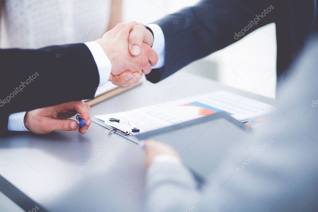 Business people shaking hands, finishing up a meeting. Business people
