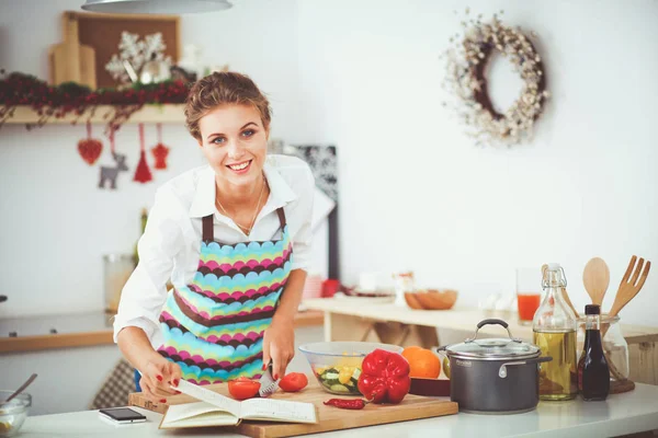 Gülümseyen genç kadın mutfakta salata hazırlık. — Stok fotoğraf