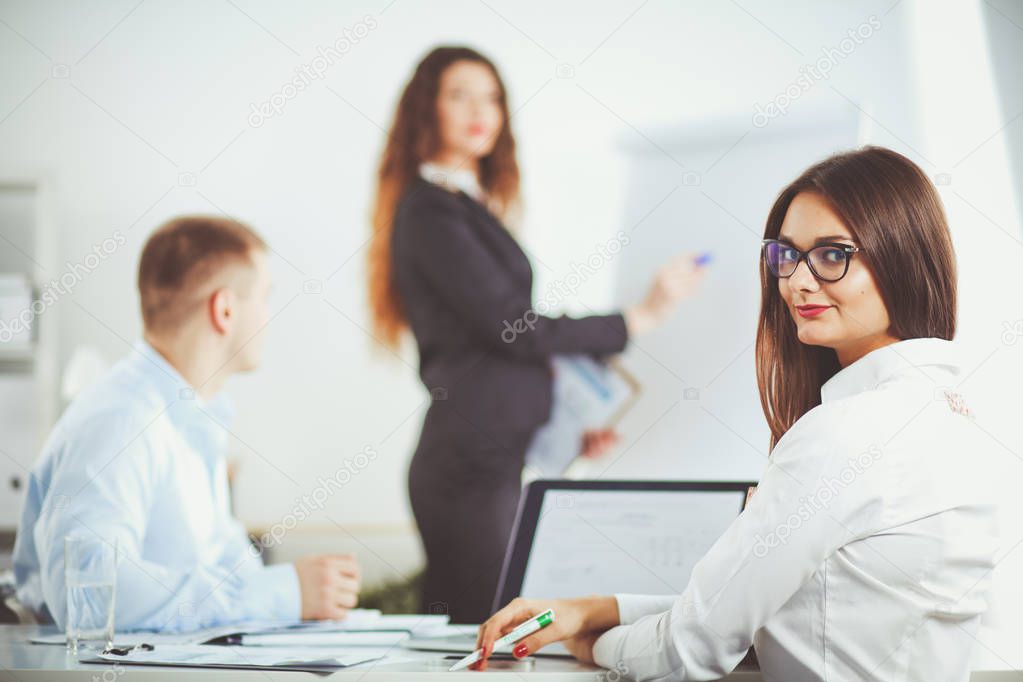 Business people sitting and discussing at business meeting, in office. Business people