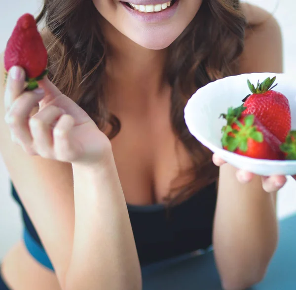 Smiling woman eating strawberry. Close up female face portrait — Stock Photo, Image