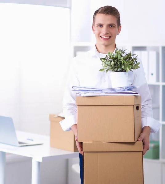 Portrait of a person with moving box and other stuff isolated on white — Stock Photo, Image