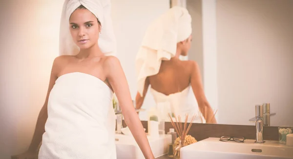 Jeune femme attrayante debout devant le miroir de salle de bain — Photo