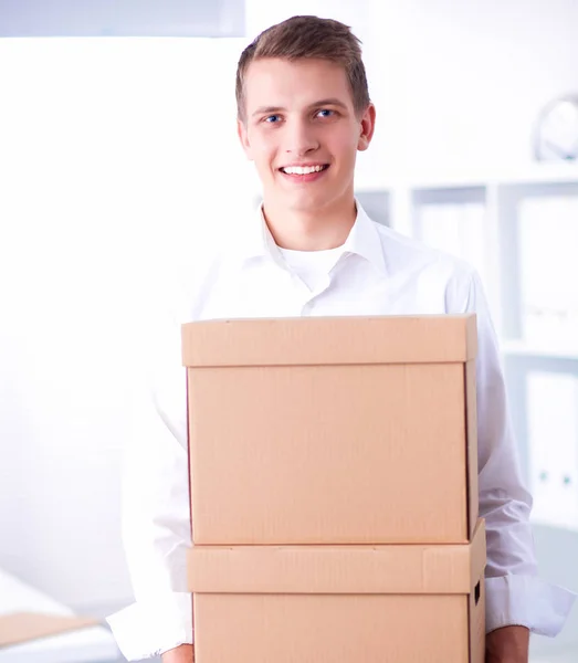 Portrait of a person with moving box and other stuff isolated on white — Stock Photo, Image