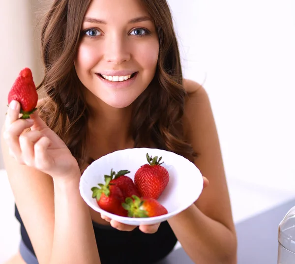 Smiling woman eating strawberry. Close up female face portrait — Stock Photo, Image