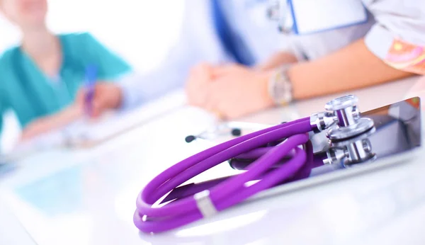 Beautiful  female doctor sitting at the desk — Stock Photo, Image