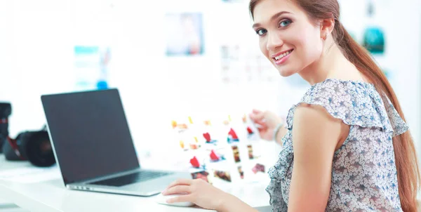 Aantrekkelijke zakenvrouw zit op het bureau in het kantoor — Stockfoto