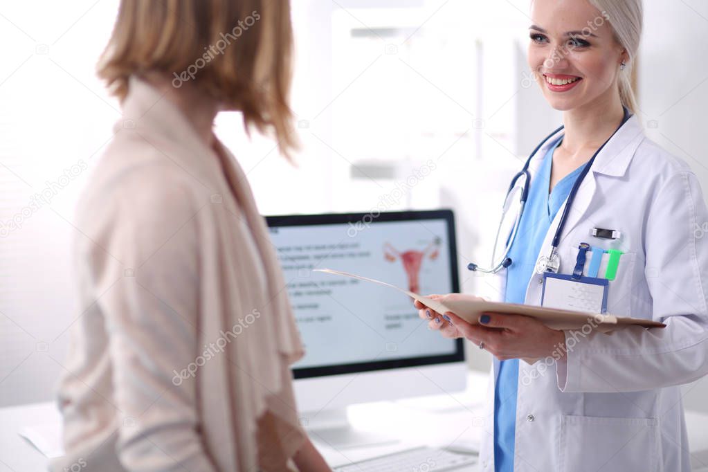 Doctor and patient discussing something while sitting at the table . Medicine and health care concept. Doctor and patient