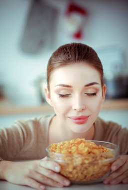 Gülümseyen çekici kadın kahvaltı mutfak iç. Gülümseyen çekici kadın.