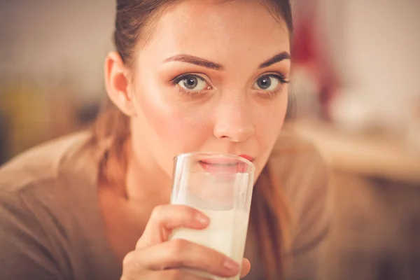 Smiling attractive woman having breakfast in kitchen interior. Smiling attractive woman.