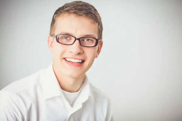 Portrait of young man smiling sitting on gray background. Portrait of young man — Stock Photo, Image