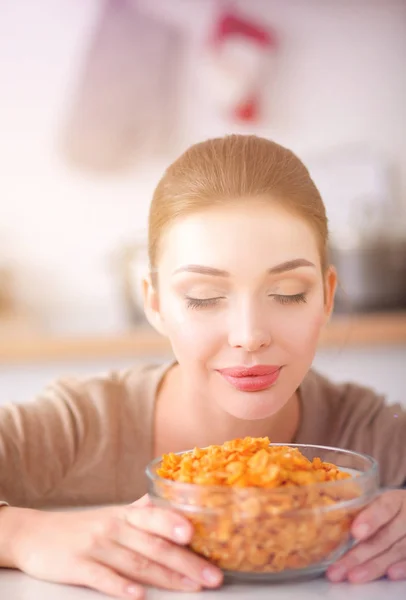 Smiling attractive woman having breakfast in kitchen interior. Smiling attractive woman.