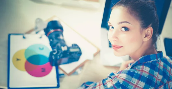 Female photographer sitting on the desk with laptop — Stock Photo, Image