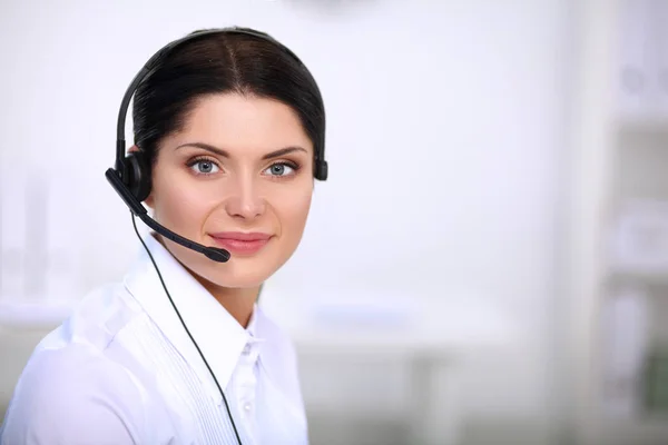 Close-up portrait of a customer service agent sitting at office — Stock Photo, Image