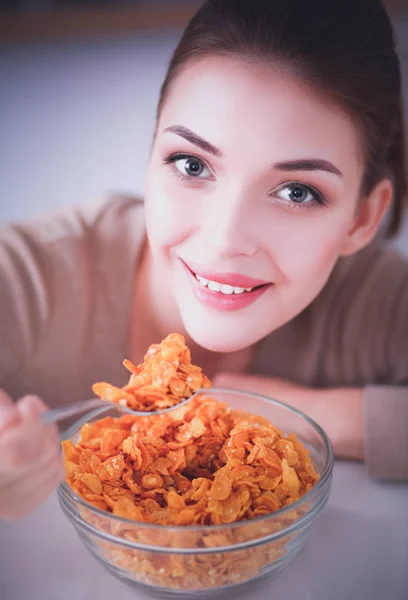 Smiling attractive woman having breakfast in kitchen interior. Smiling attractive woman.