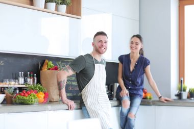 Güzel genç çift evde mutfakta eğleniyor.