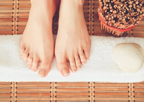 Care for beautiful woman legs on a towel. Beautiful woman legs — Stock Photo, Image