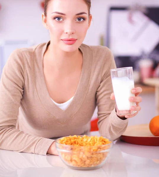 Smiling attractive woman having breakfast in kitchen interior — Stock Photo, Image