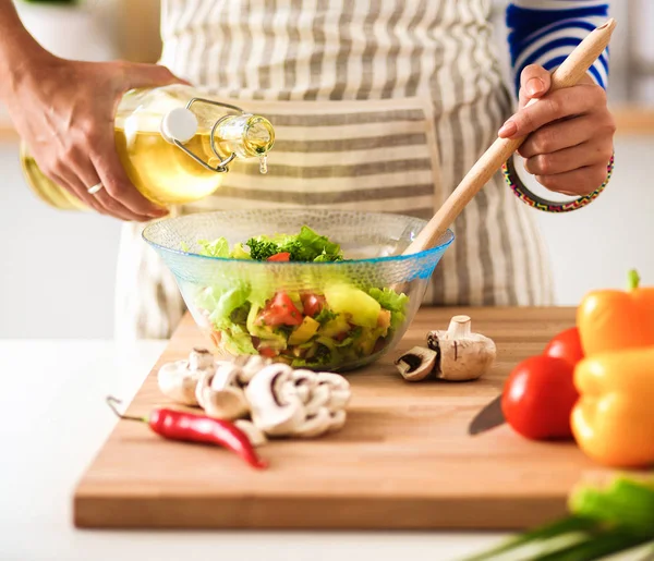 Mujer joven mezclando ensalada fresca — Foto de Stock