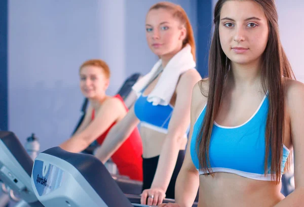Group of people at the gym exercising on cross trainers. people at the gym — Stock Photo, Image
